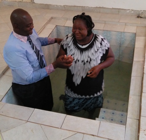 Pastor Justin baptizing his wife. 