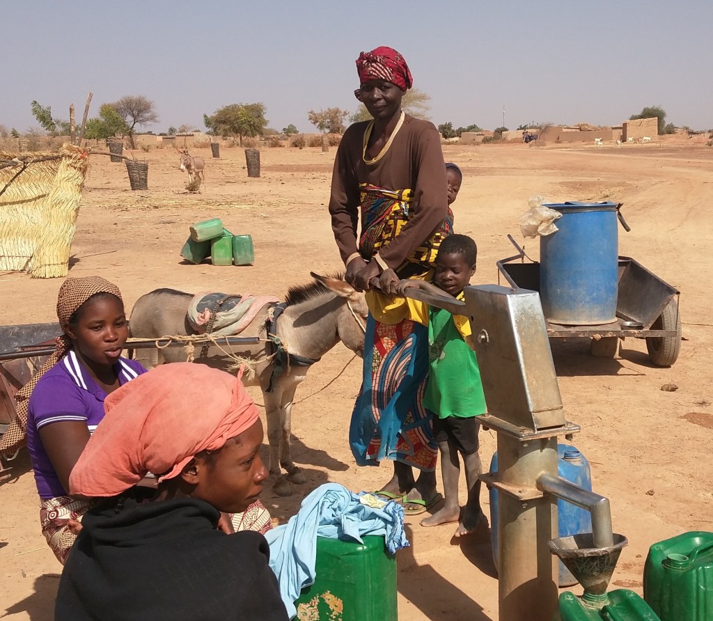 Woman pumping with child helping